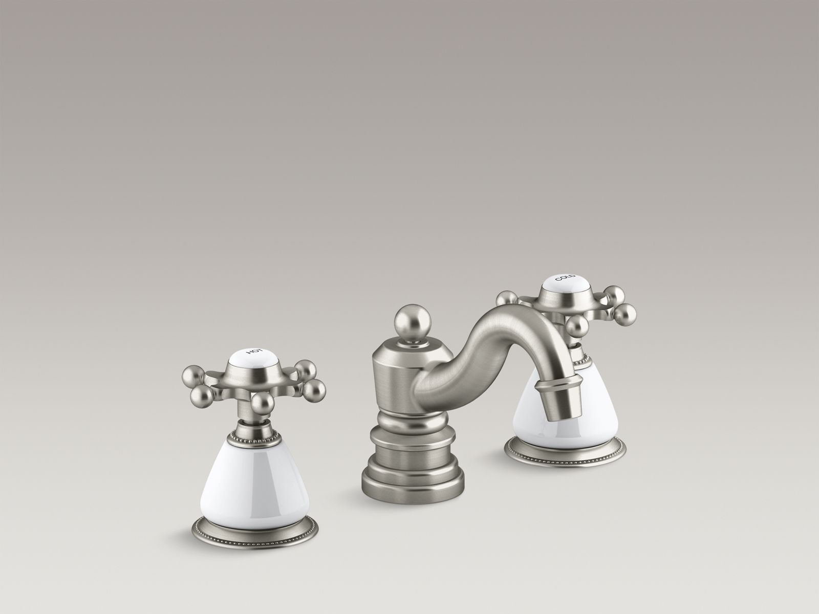 Antique widespread bathroom sink faucet with 6-prong handles and ceramic skirts