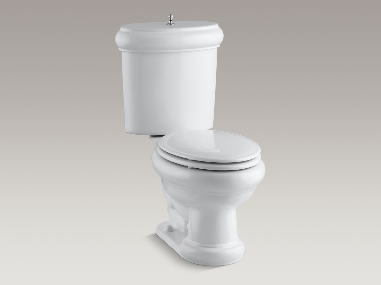 Revival(R) two-piece elongated 1.6 GPF toilet with seat, Brushed Chrome flush actuator and trim