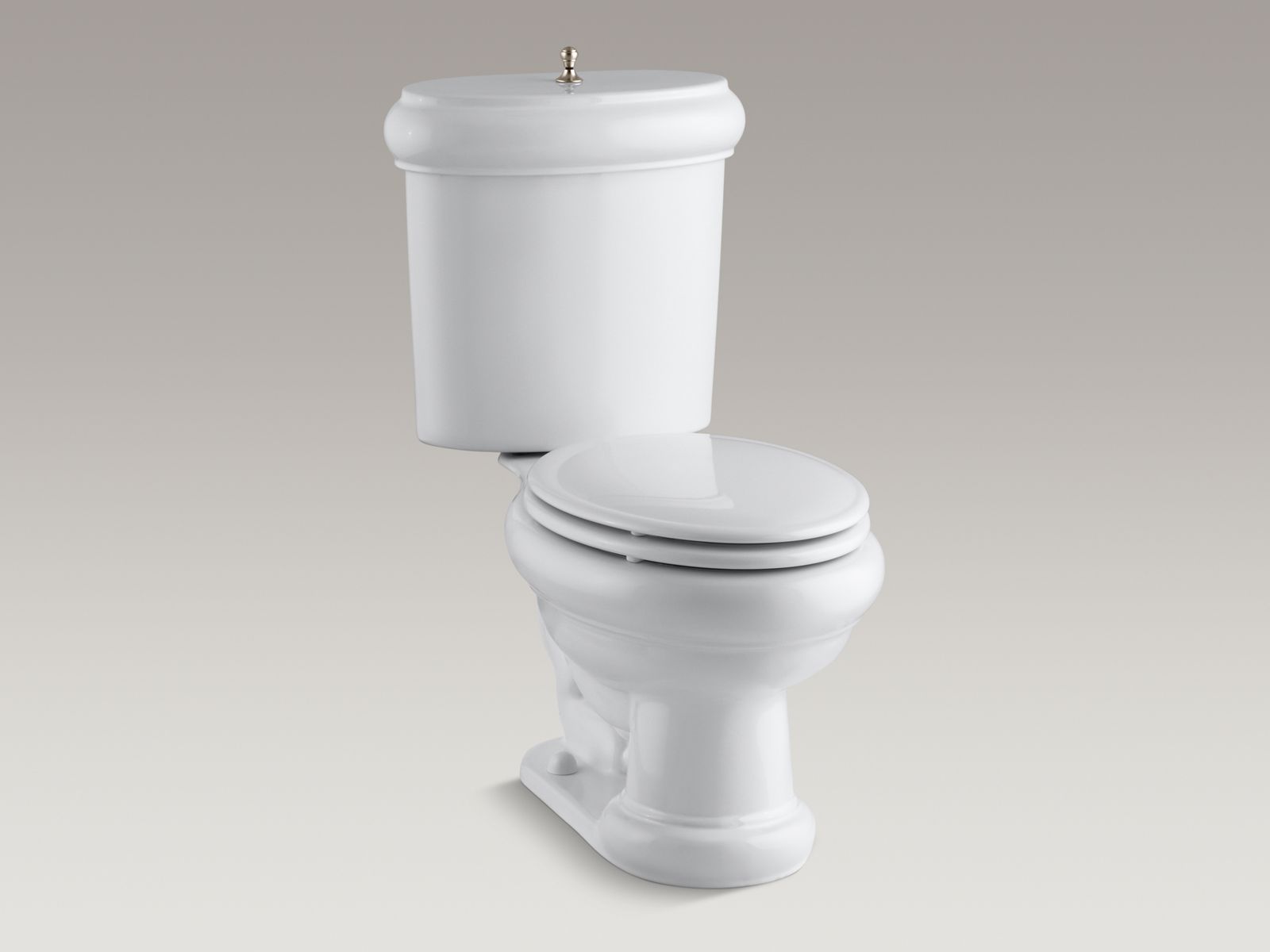 Revival(R) two-piece elongated 1.6 GPF toilet with seat, Vibrant(R) Brushed Bronze flush actuator and trim